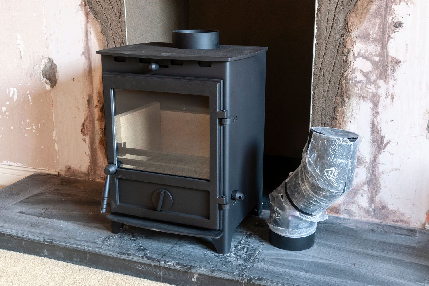 Professional log burner installation in progress at Sutton Coldfield home by HETAS certified installer